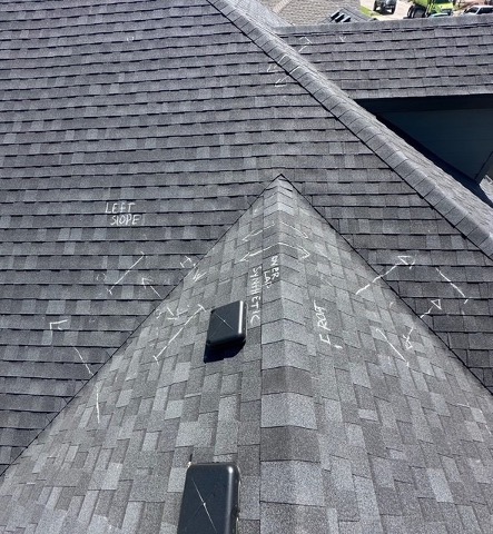Storm-damaged shingle roof during an inspection