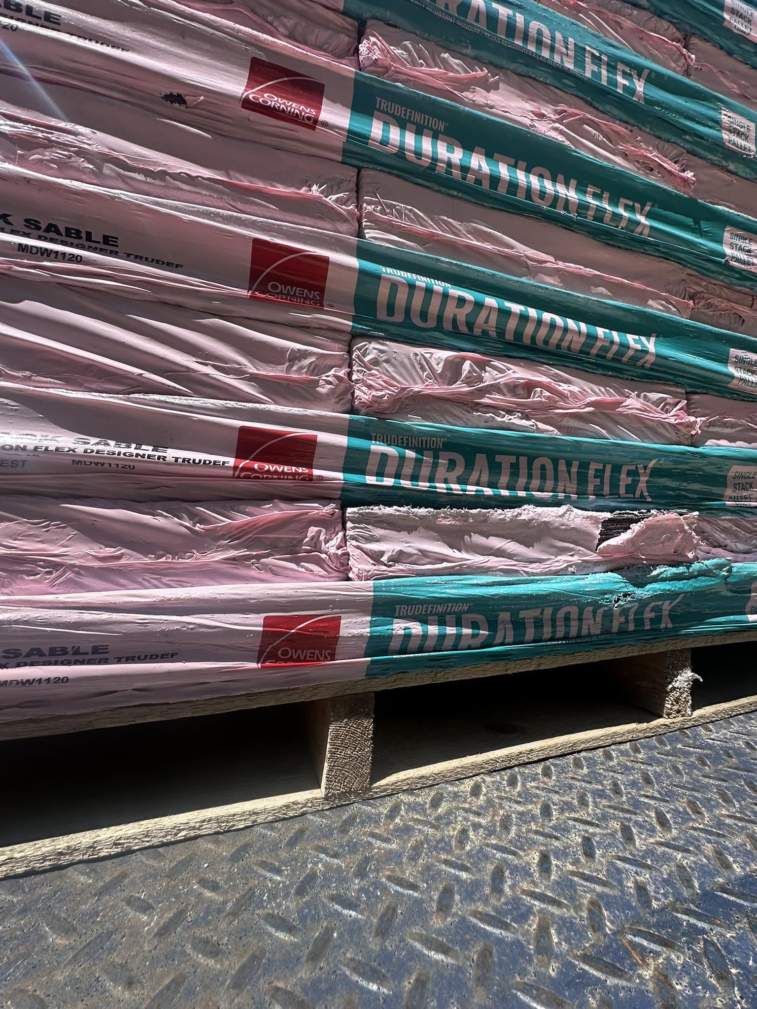 Pallets of Class 4 impact-resistant architectural shingles ready for installation