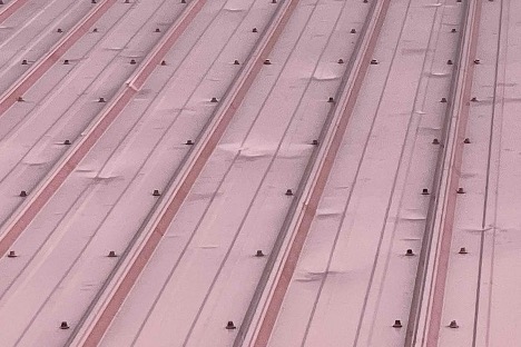 Hail impact marks on a standing seam metal roof